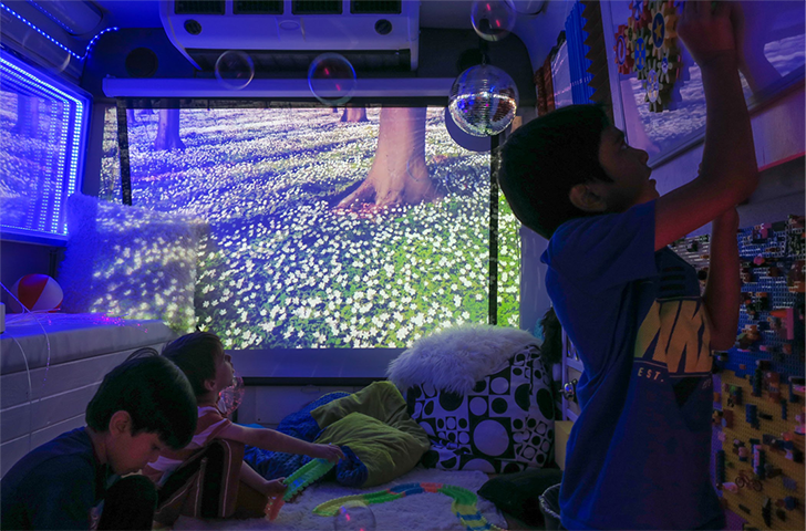Three kids playing in a sensory room